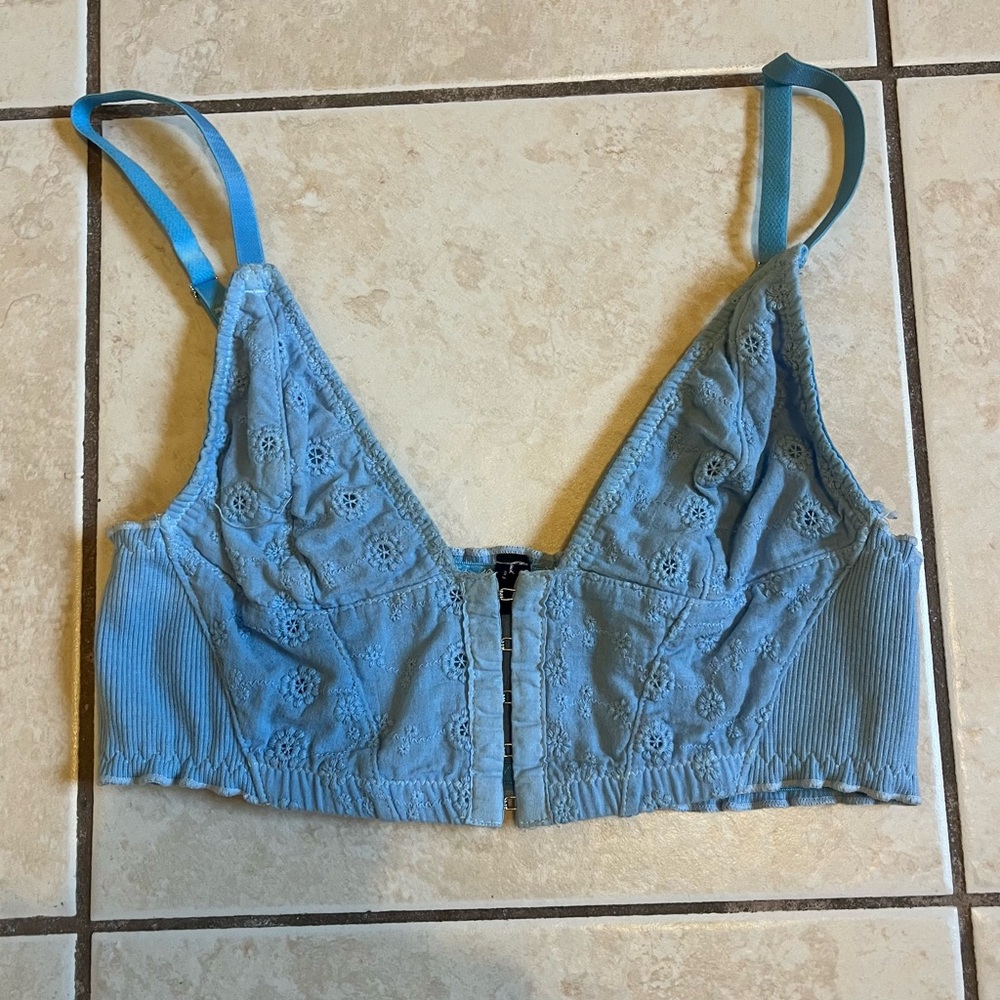 Out from under blue corset style top